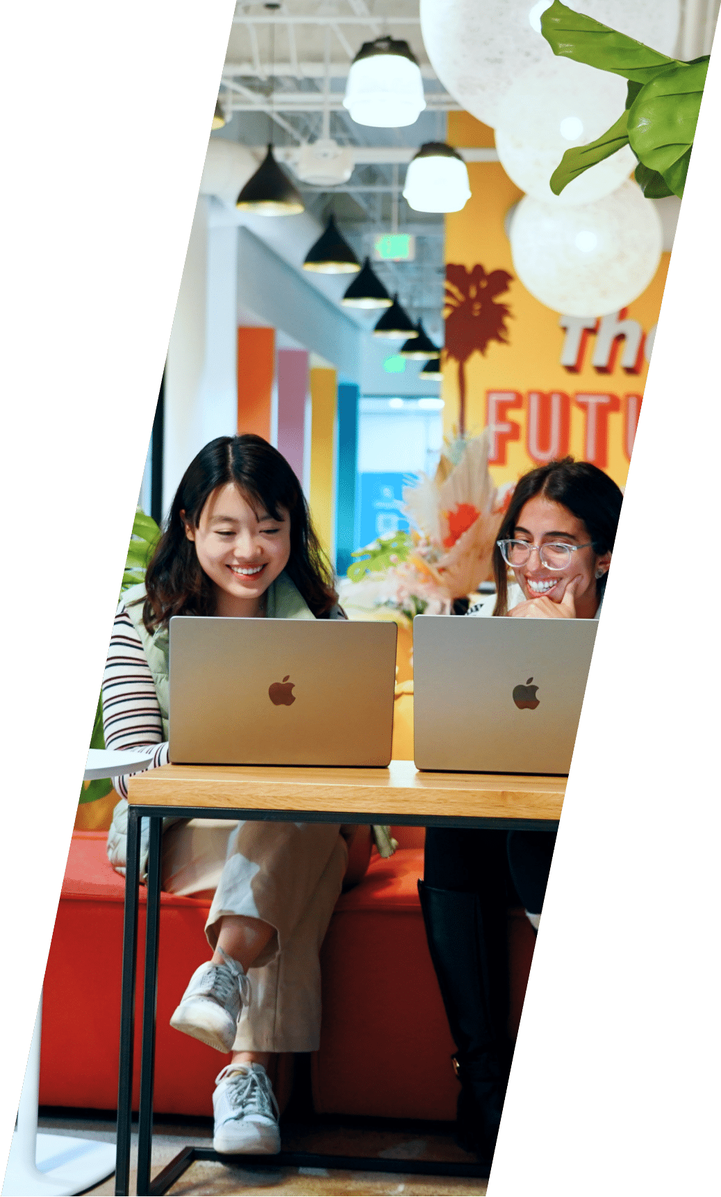 Team working together on laptops in a colorful office